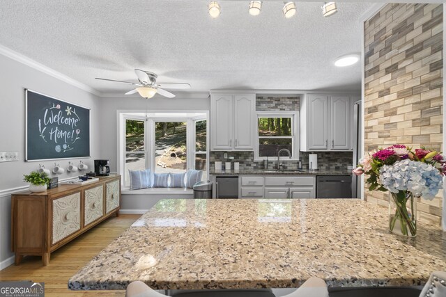 3928 Lake Ct, Gainesville, GA 30501 - kitchen with light stone countertops, ceiling fan, a sink, light wood finished floors, and black dishwasher