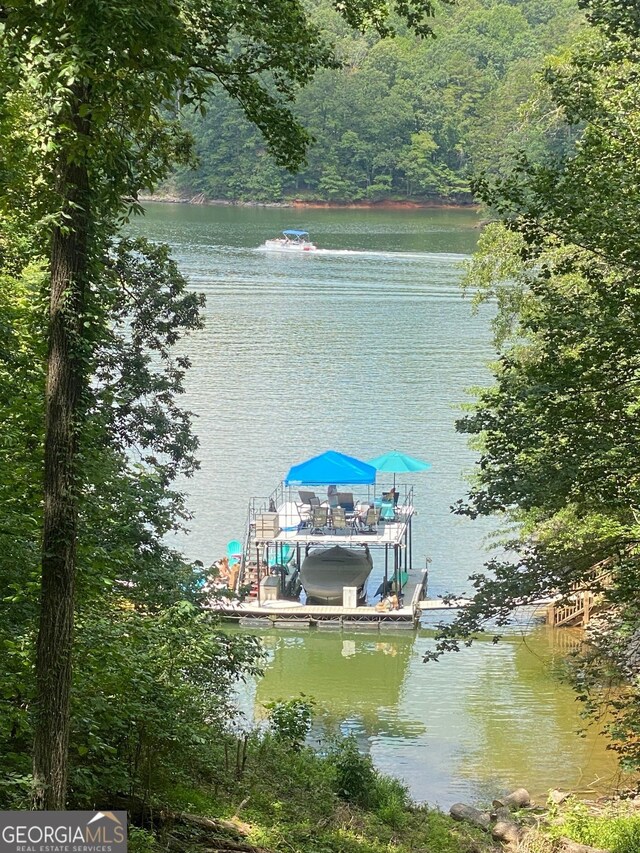 3928 Lake Ct, Gainesville, GA 30501 - dock area featuring a water view, boat lift, and a wooded view