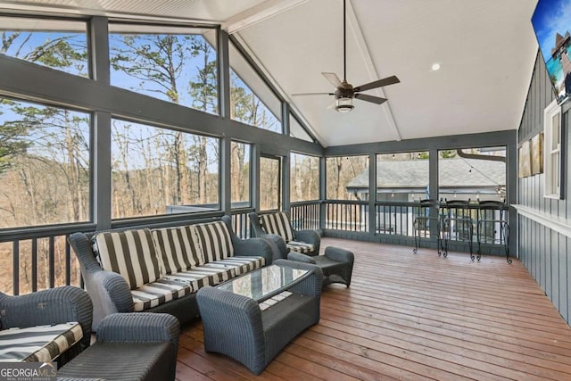 sunroom / solarium with lofted ceiling and a ceiling fan