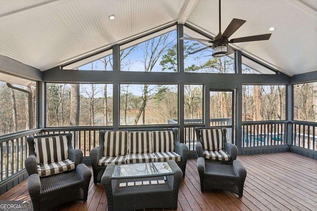 sunroom / solarium featuring lofted ceiling and ceiling fan