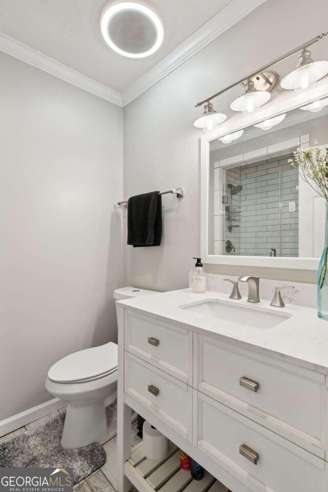 3928 Lake Ct, Gainesville, GA 30501 - bathroom with crown molding, vanity, toilet, and a shower stall