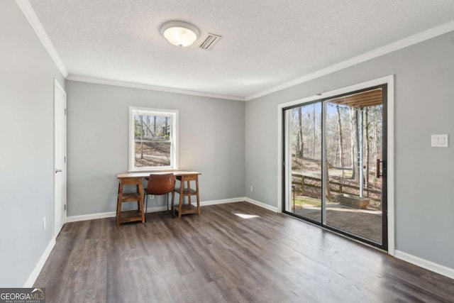 spare room with baseboards, visible vents, wood finished floors, and ornamental molding