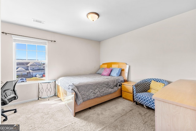 carpeted bedroom with baseboards and visible vents