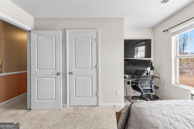 bedroom with visible vents, baseboards, and carpet flooring