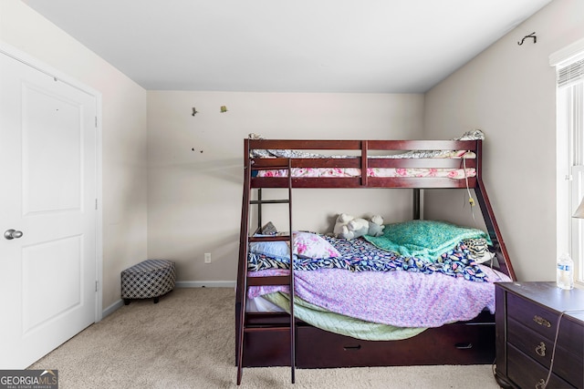 carpeted bedroom featuring baseboards