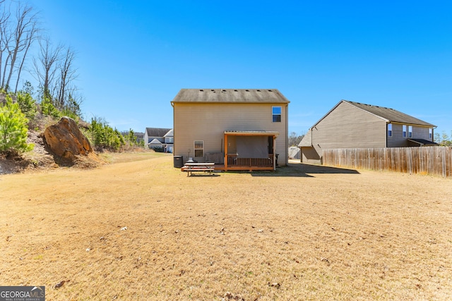 back of house with a deck and fence