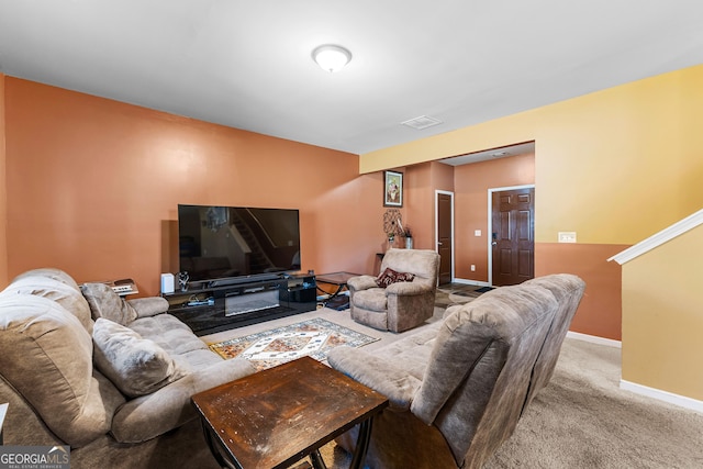 carpeted living area with visible vents and baseboards