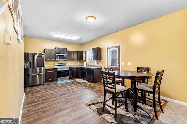 dining room featuring dark wood finished floors and baseboards