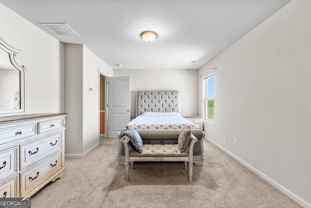 bedroom with baseboards, visible vents, and light carpet