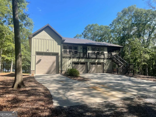 view of front of house featuring stairway, board and batten siding, and concrete driveway