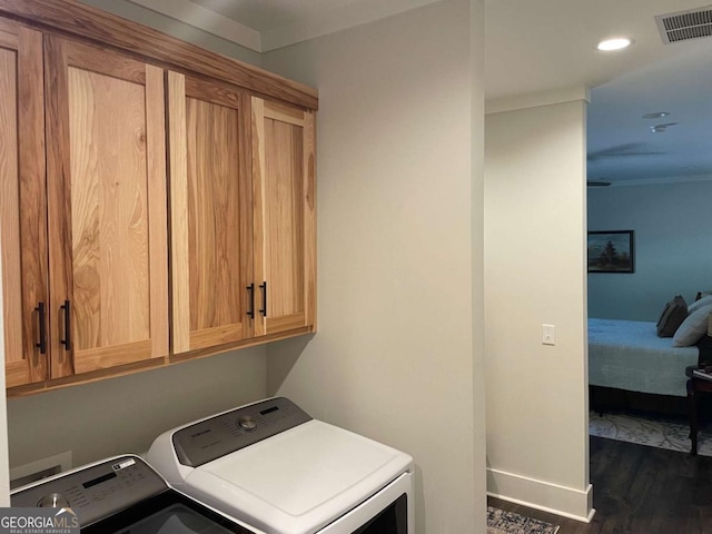 clothes washing area with cabinet space, baseboards, visible vents, dark wood-style flooring, and separate washer and dryer