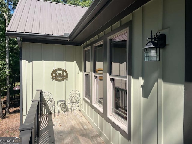 view of property exterior featuring board and batten siding and metal roof