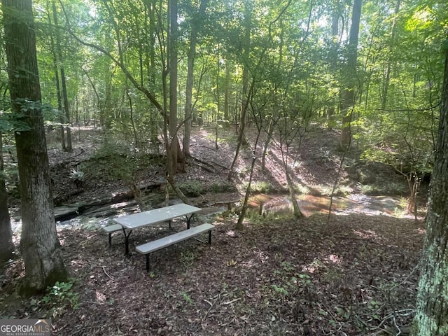 exterior space featuring a forest view