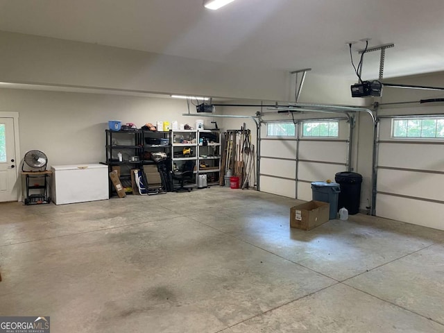 garage with fridge and a garage door opener