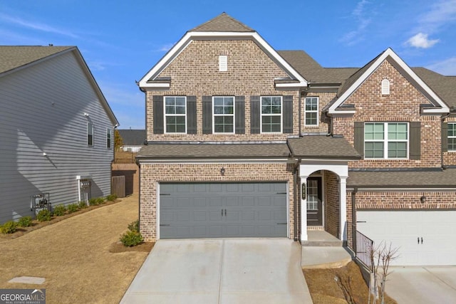 view of front of home featuring brick siding, an attached garage, concrete driveway, and a shingled roof