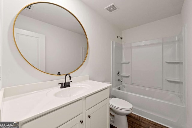 full bath featuring visible vents, toilet, wood finished floors, vanity, and shower / bathtub combination