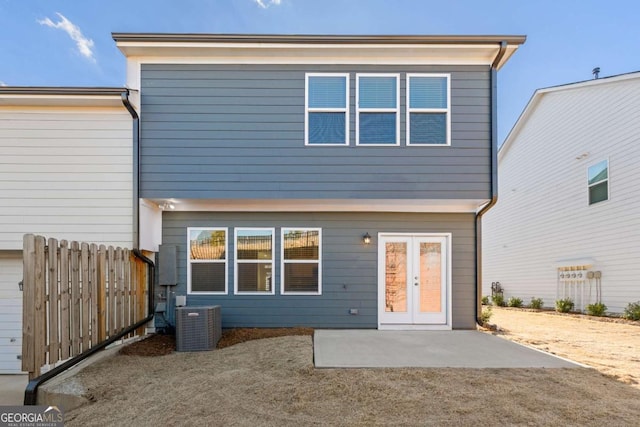 rear view of property with a patio area, central AC unit, and fence