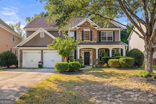 view of front facade featuring an attached garage, driveway, stone siding, and a front yard