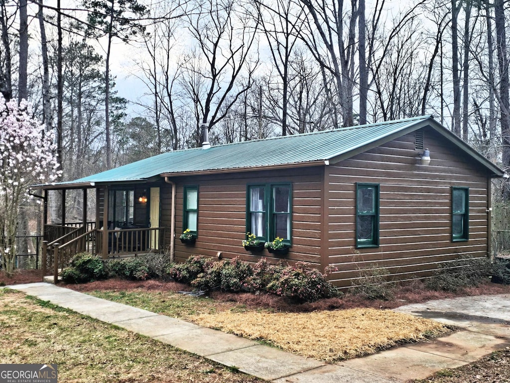 view of front of house featuring covered porch and metal roof