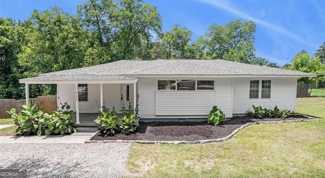 single story home featuring a front yard, covered porch, and fence