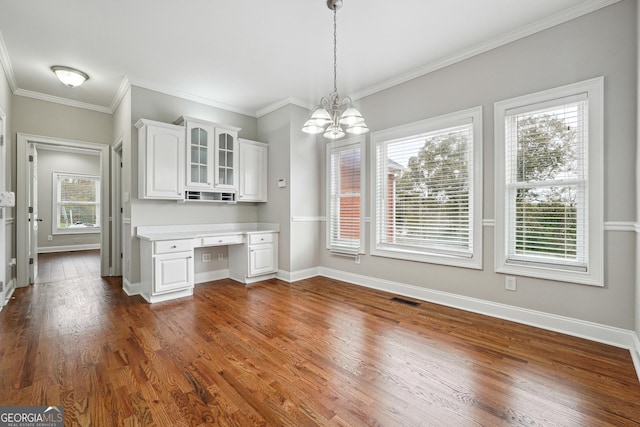 kitchen featuring white cabinetry, dark wood-style flooring, built in desk, and light countertops