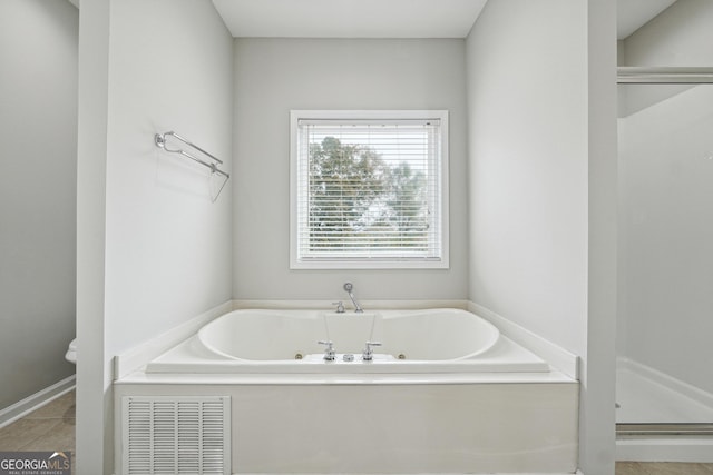 full bath with a jetted tub, a shower stall, visible vents, and tile patterned floors