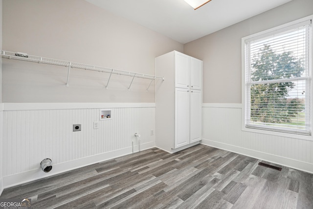 washroom with a healthy amount of sunlight, washer hookup, wood finished floors, and hookup for an electric dryer