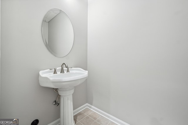 bathroom with baseboards and tile patterned floors