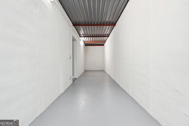 hall with concrete flooring