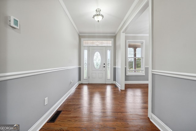 foyer with baseboards, dark wood-style flooring, visible vents, and crown molding