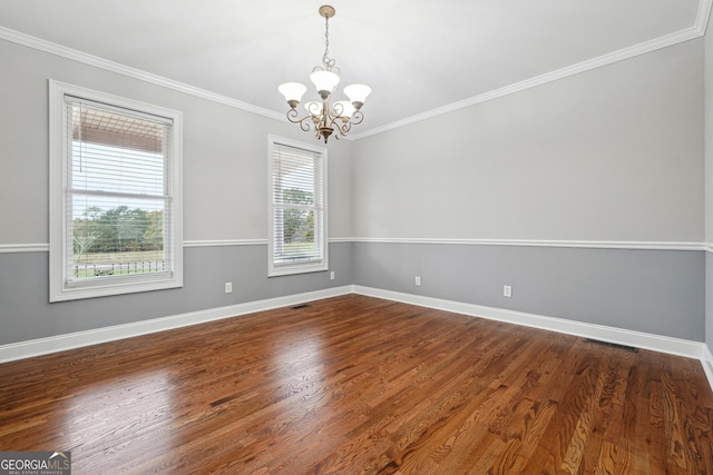 unfurnished room with dark wood-style flooring, crown molding, baseboards, and an inviting chandelier