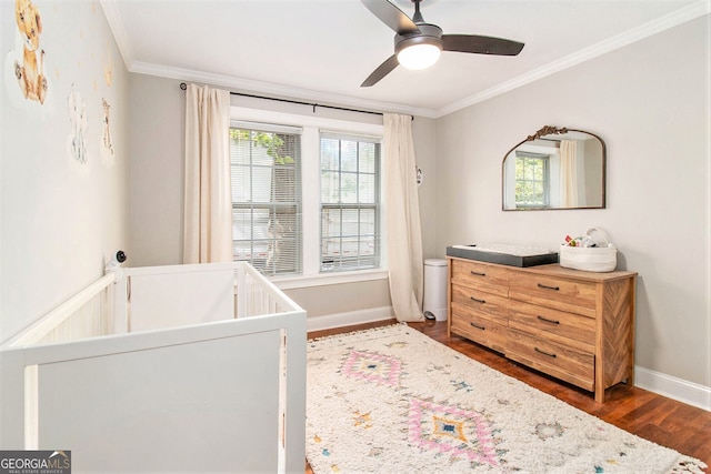bedroom with a ceiling fan, baseboards, dark wood-style flooring, and crown molding