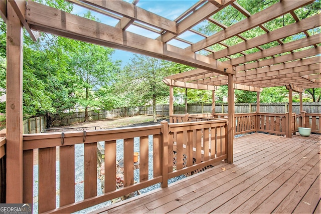 wooden deck with a fenced backyard and a pergola