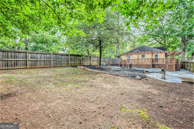 view of yard with a fenced backyard and a deck