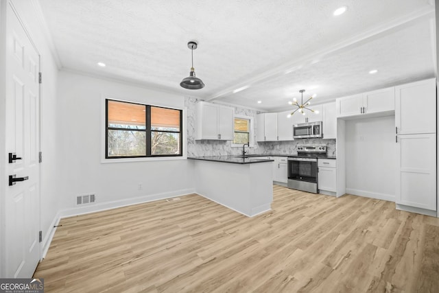 kitchen featuring visible vents, white cabinets, appliances with stainless steel finishes, tasteful backsplash, and dark countertops