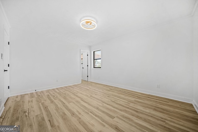 spare room featuring light wood-style floors and baseboards