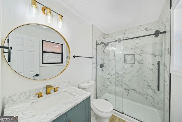 bathroom with vanity, a marble finish shower, and toilet