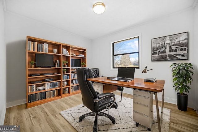 office featuring ornamental molding, wood finished floors, and baseboards