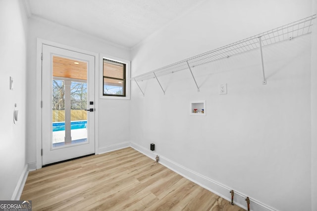 laundry room with baseboards, laundry area, hookup for a washing machine, and light wood-style floors