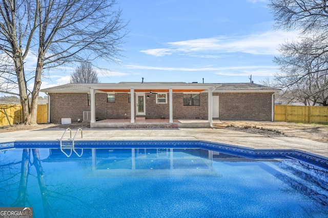 view of pool featuring ceiling fan, a fenced in pool, a patio, and fence