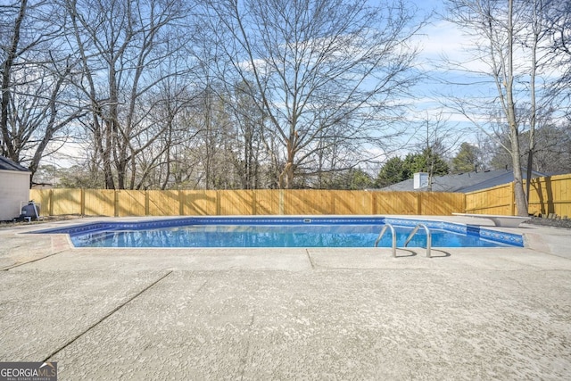 view of pool featuring a patio area, a fenced backyard, a diving board, and a fenced in pool