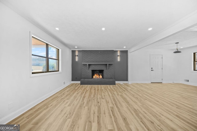 unfurnished living room featuring recessed lighting, a fireplace, light wood-style flooring, and baseboards