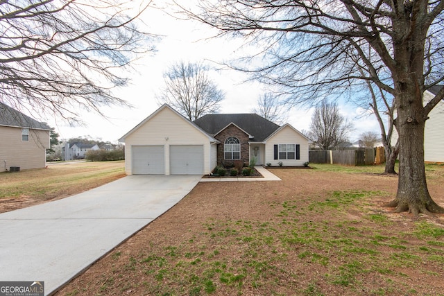 ranch-style house with an attached garage, fence, and a front lawn