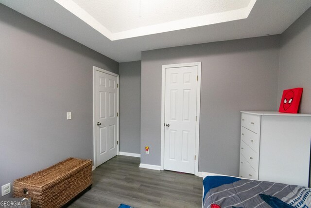 bedroom with baseboards and wood finished floors