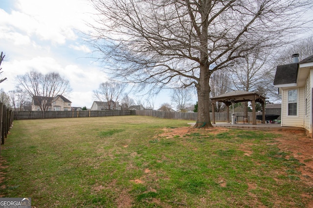 view of yard featuring a fenced backyard and a gazebo