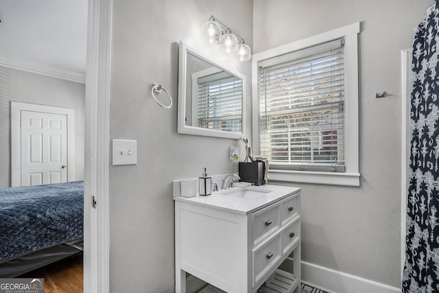 full bathroom featuring vanity, crown molding, wood finished floors, and baseboards