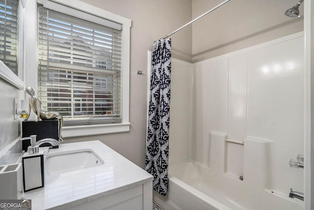 bathroom featuring shower / bath combo and vanity