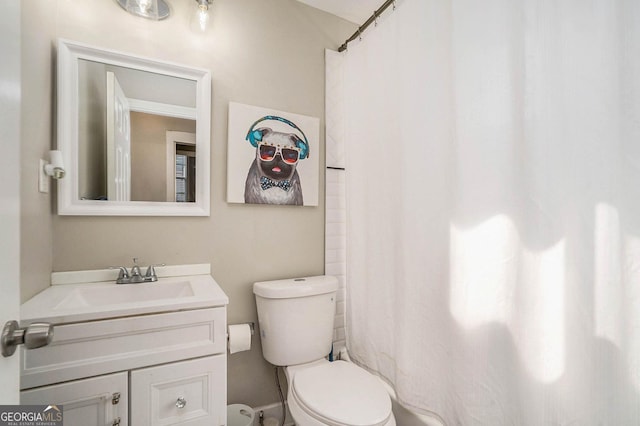 bathroom featuring vanity, a shower with shower curtain, and toilet