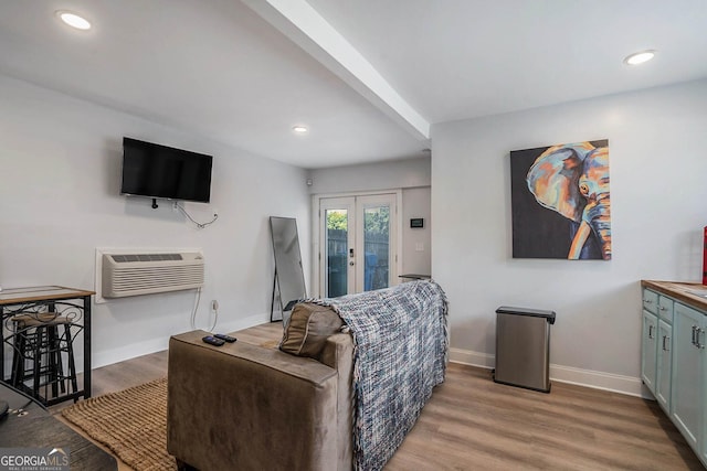 living room with recessed lighting, french doors, light wood-type flooring, and baseboards