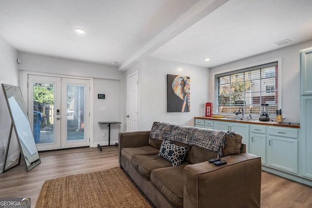 living area featuring visible vents, recessed lighting, french doors, and light wood-style floors